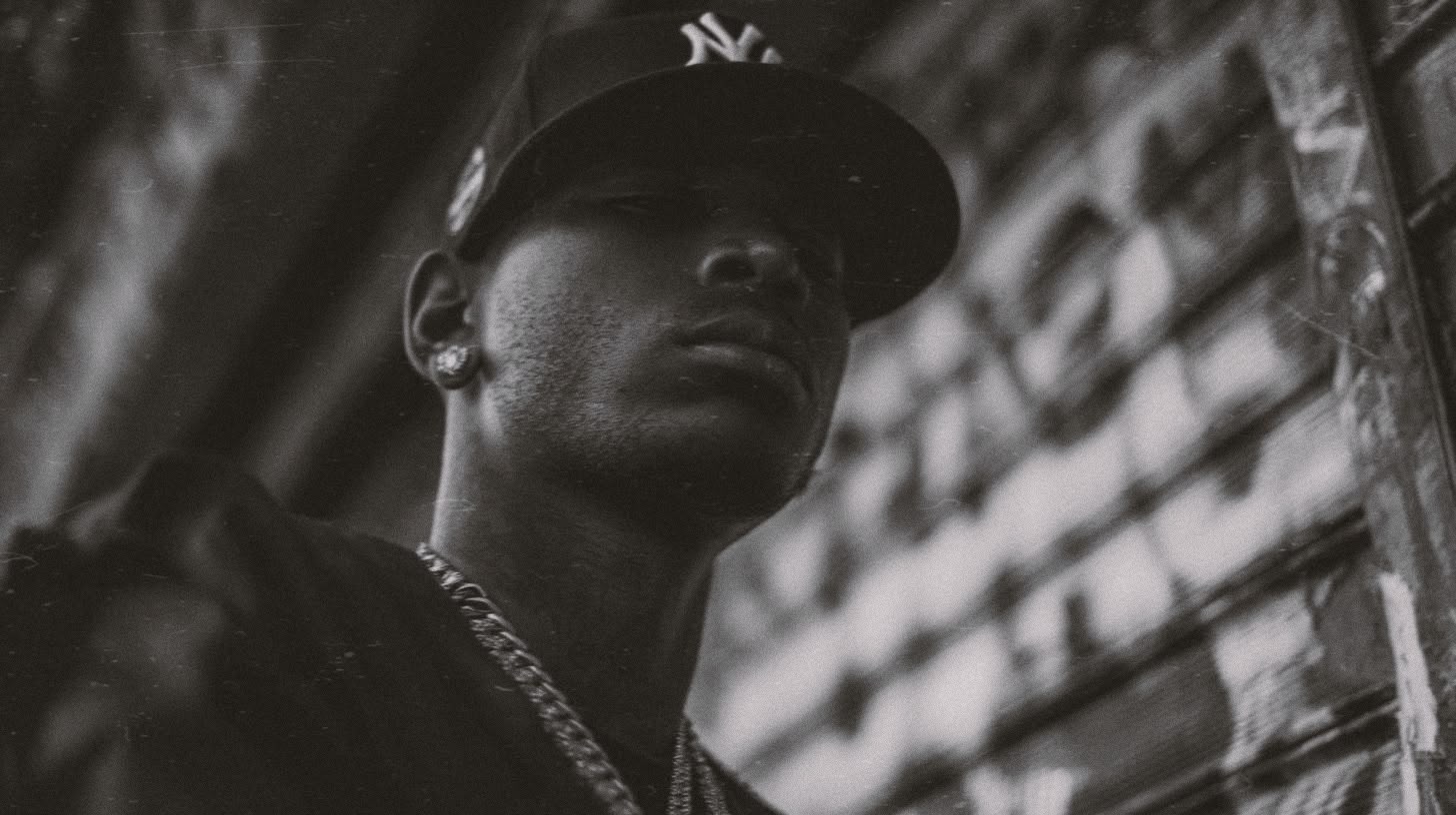 Collector in a New York cap against a graffiti wall